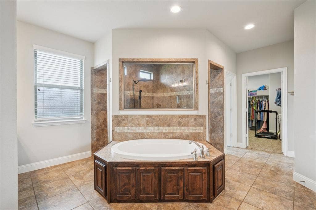 Primary bathroom featuring a jetted tub.