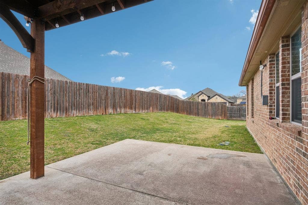 Covered patio with outdoor seating, ideal for relaxing and entertaining.