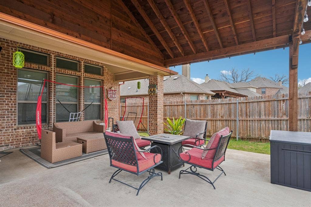 Covered patio with outdoor seating, ideal for relaxing and entertaining.