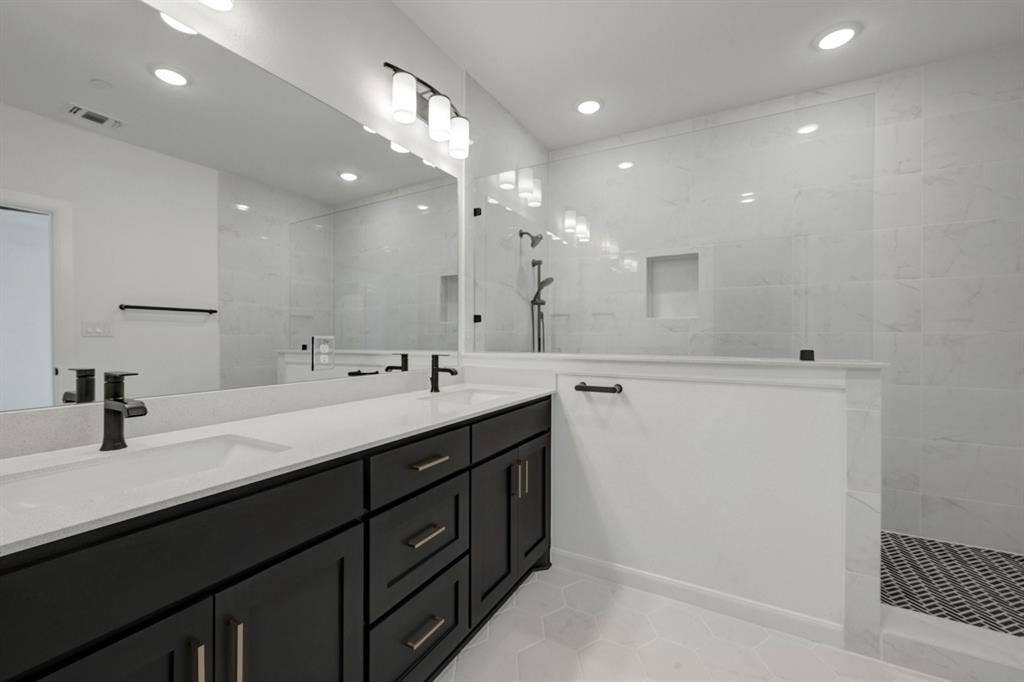 2852 Yampa Drive, McKinney, TX 75071 Bathroom featuring a dual vanity with dark wood-finish cabinetry and light-toned countertops