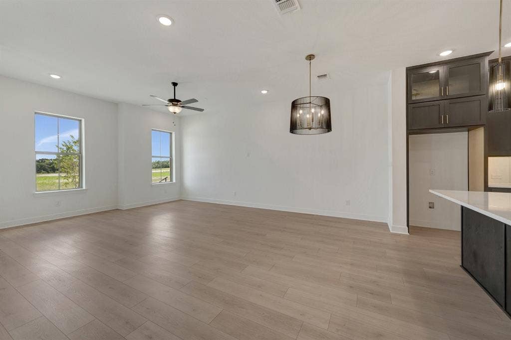 2852 Yampa Drive, McKinney, TX 75071 Open concept living area featuring light wood-finish flooring, recessed lighting, and a ceiling fan