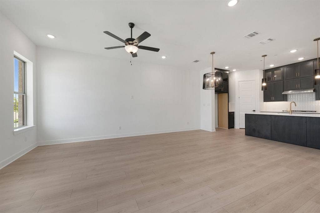 2852 Yampa Drive, McKinney, TX 75071 Expansive room featuring light wood-finish flooring and recessed lighting