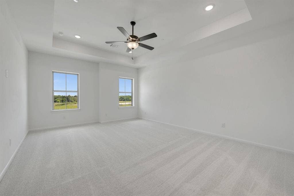 2852 Yampa Drive, McKinney, TX 75071 Spacious room featuring light-colored carpeting and white walls