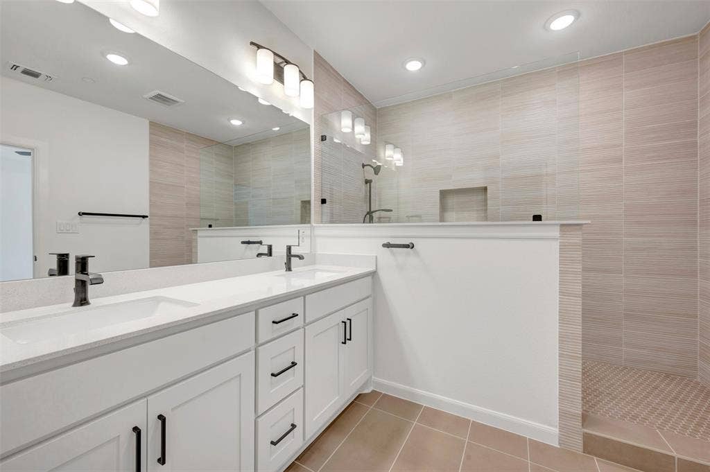 2860 Yampa Drive, McKinney, TX 75071 Contemporary bathroom featuring a dual vanity with white cabinetry, quartz countertops, and matte black fixtures