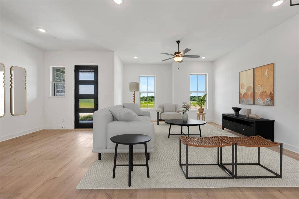 2860 Yampa Drive, McKinney, TX 75071 Spacious living area featuring light wood-finish flooring, recessed lighting, and a contemporary ceiling fan