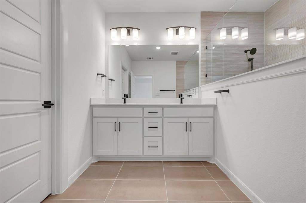2860 Yampa Drive, McKinney, TX 75071 Dual white vanities with quartz-finish countertops and integrated sinks