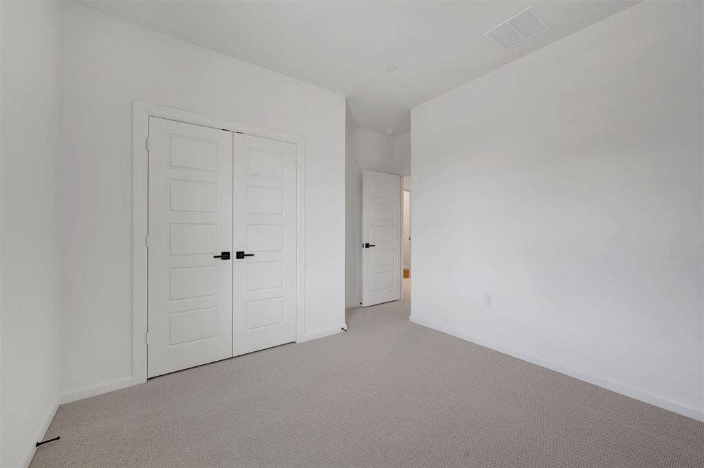 2860 Yampa Drive, McKinney, TX 75071 Neutral tone carpeting extends throughout this room, featuring white walls and white trim