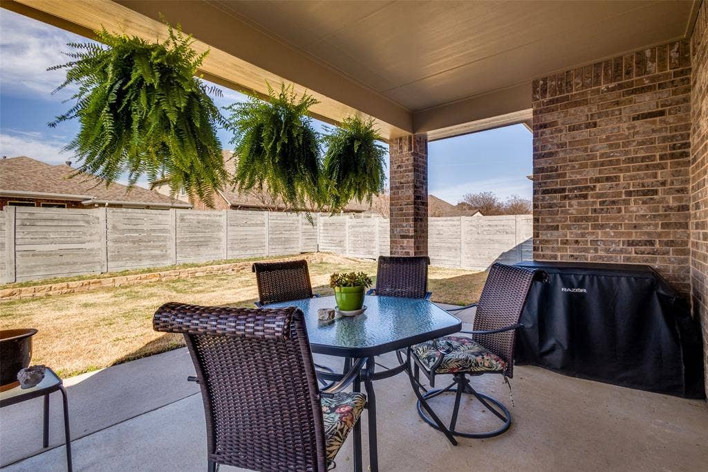 Nicley covered patios leads to a large backyard suitable for lots of outside play.