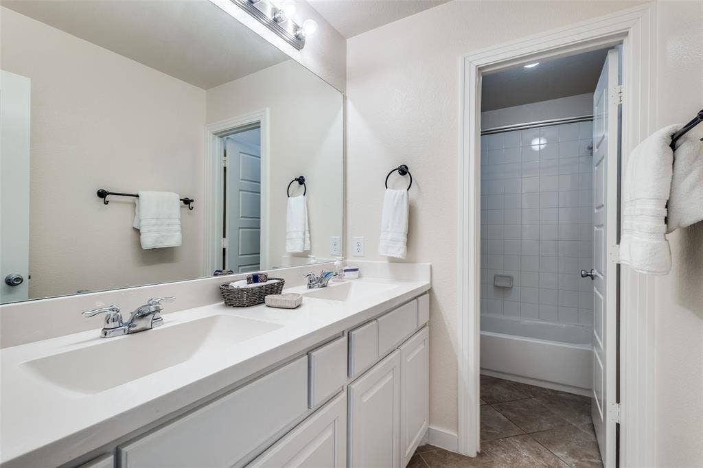 The upstairs bath has a convenient door that allows more than one person to be in the bathroom during hectic mornings.