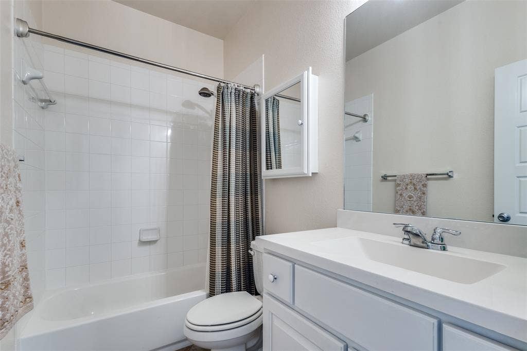 The secondary bath on the first floor serves both visitors and the secondary bedroom on the main floor.