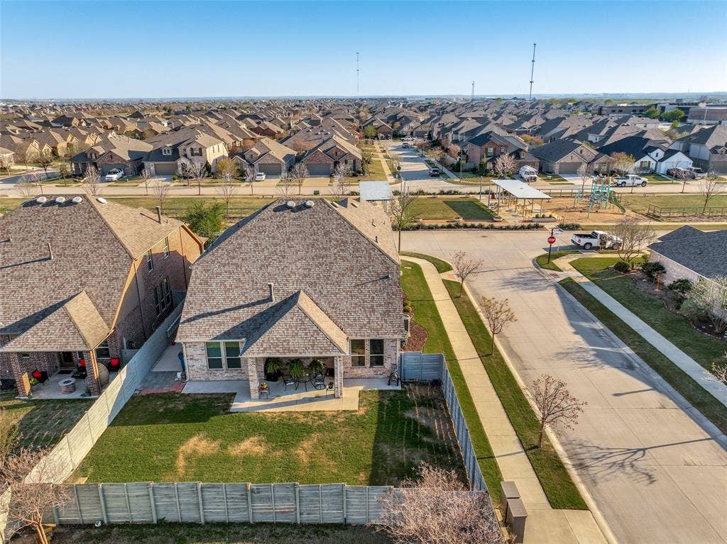 1836 Harrier Ln from the back showing the oversized backyard and park across the street