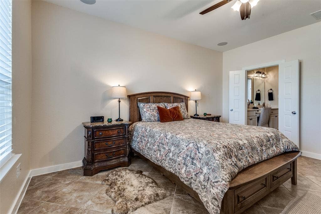 An en-suite bath with jetted tub, shower and vanity area leads to a generous primary closet.