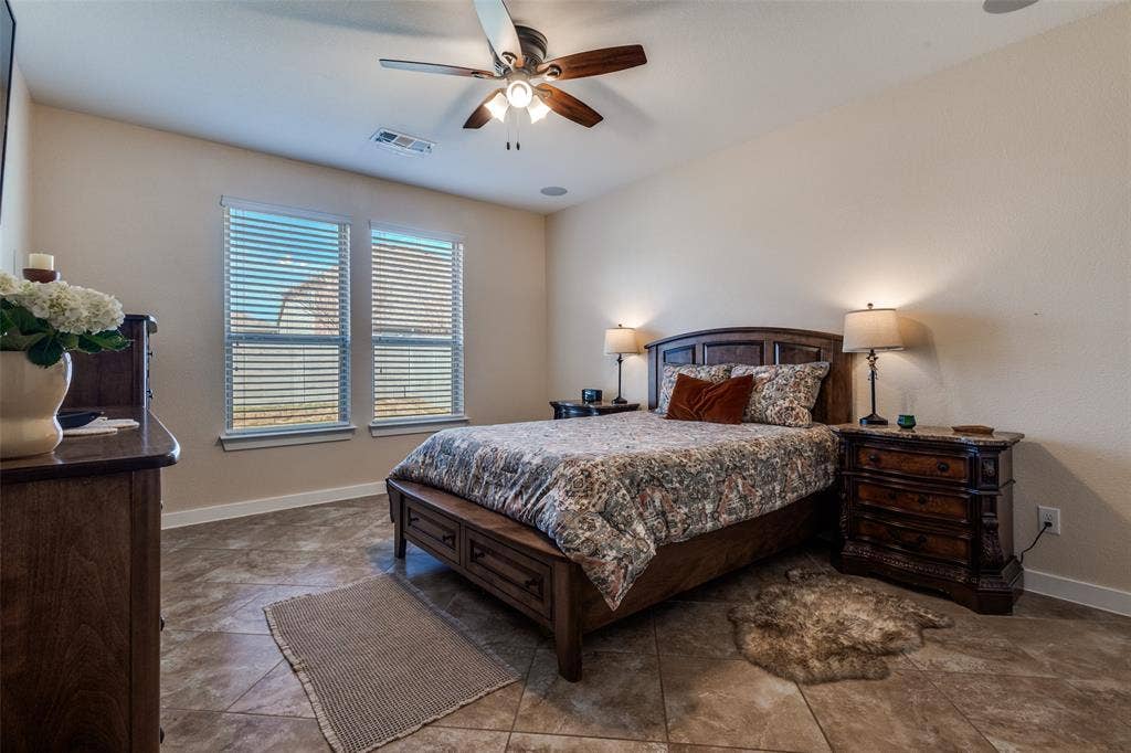 The primary bedroom looks out the back of the house and is large enough for a sitting area and kingsize bed.