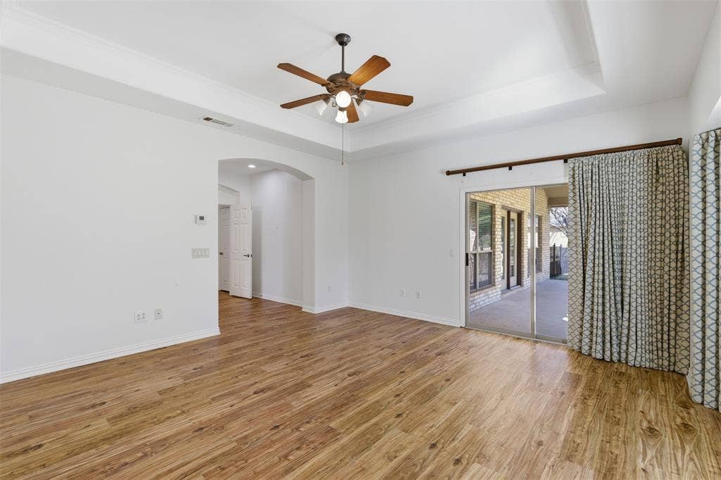 Patio doors in the primary bedroom open to the covered porch