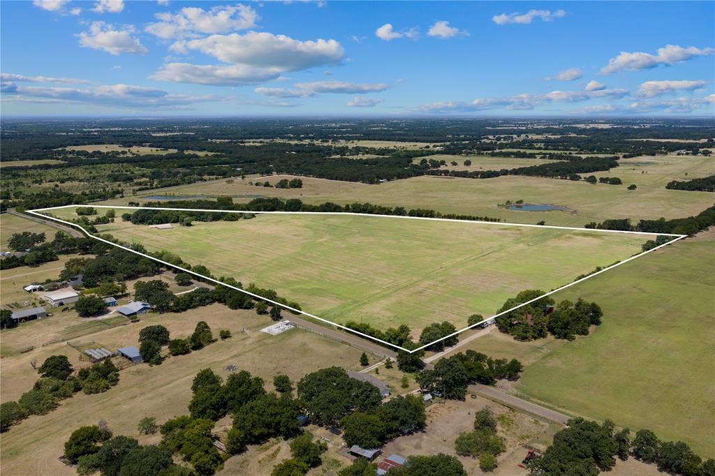 Expansive open fields with tree-lined boundaries