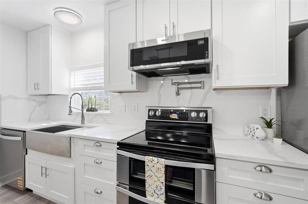 2518 W Amherst Avenue, Dallas, TX 75235 Sleek stainless steel appliances complete the modern kitchen.