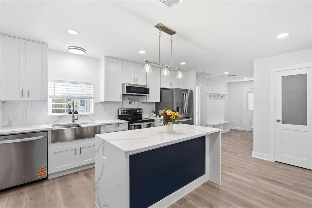 2518 W Amherst Avenue, Dallas, TX 75235 Gourmet kitchen featuring a large island and stunning quartz countertops, perfect for cooking and entertaining.