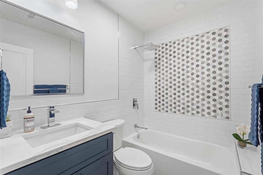 2518 W Amherst Avenue, Dallas, TX 75235 Upgraded bathroom featuring brand new tile and custom cabinetry for a fresh, modern feel.
