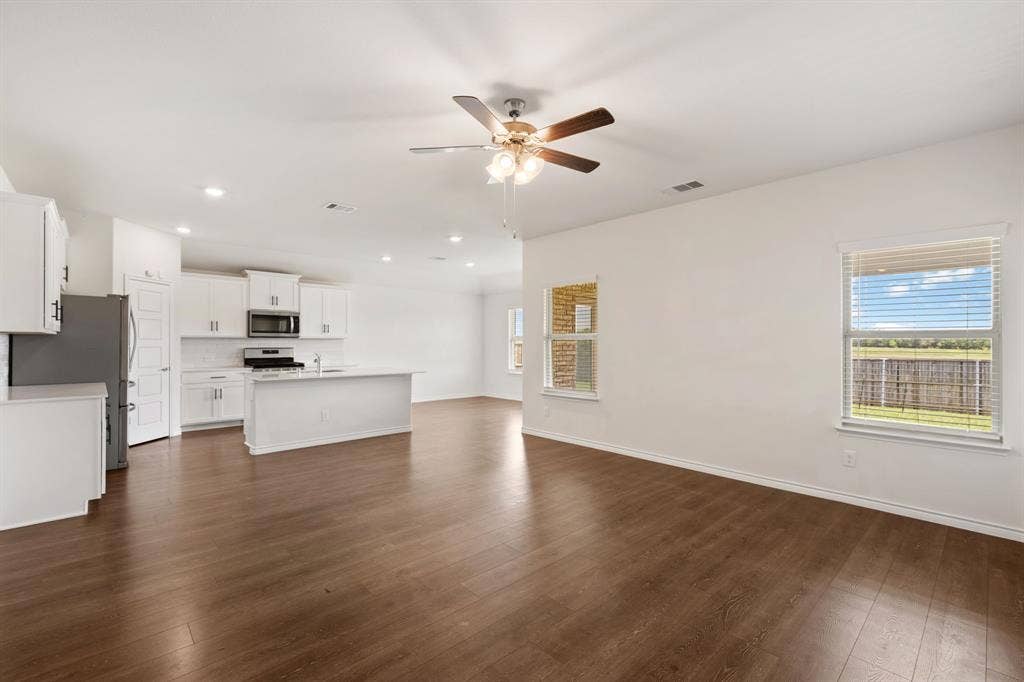 653 Bunker Hill Road, Fate, TX 75189 Open-concept living area featuring wood-finish flooring