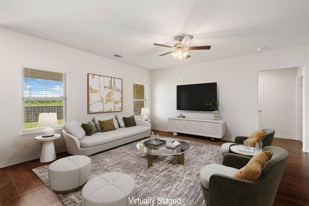653 Bunker Hill Road, Fate, TX 75189 Open-concept living space featuring wood-finish flooring, white walls, and a ceiling fan