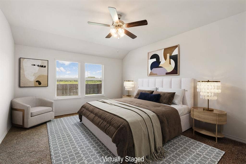 653 Bunker Hill Road, Fate, TX 75189 Bedroom featuring white walls, a vaulted ceiling, a ceiling fan with light fixture, and two windows