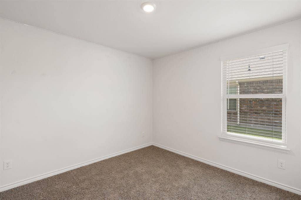 653 Bunker Hill Road, Fate, TX 75189 Neutral color palette featuring white walls, white trim, and brown carpet