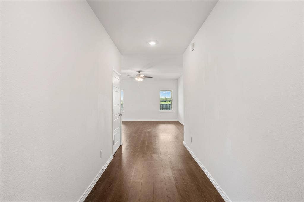 653 Bunker Hill Road, Fate, TX 75189 Hallway with wood-finish flooring, white walls, recessed lighting, and a white interior door