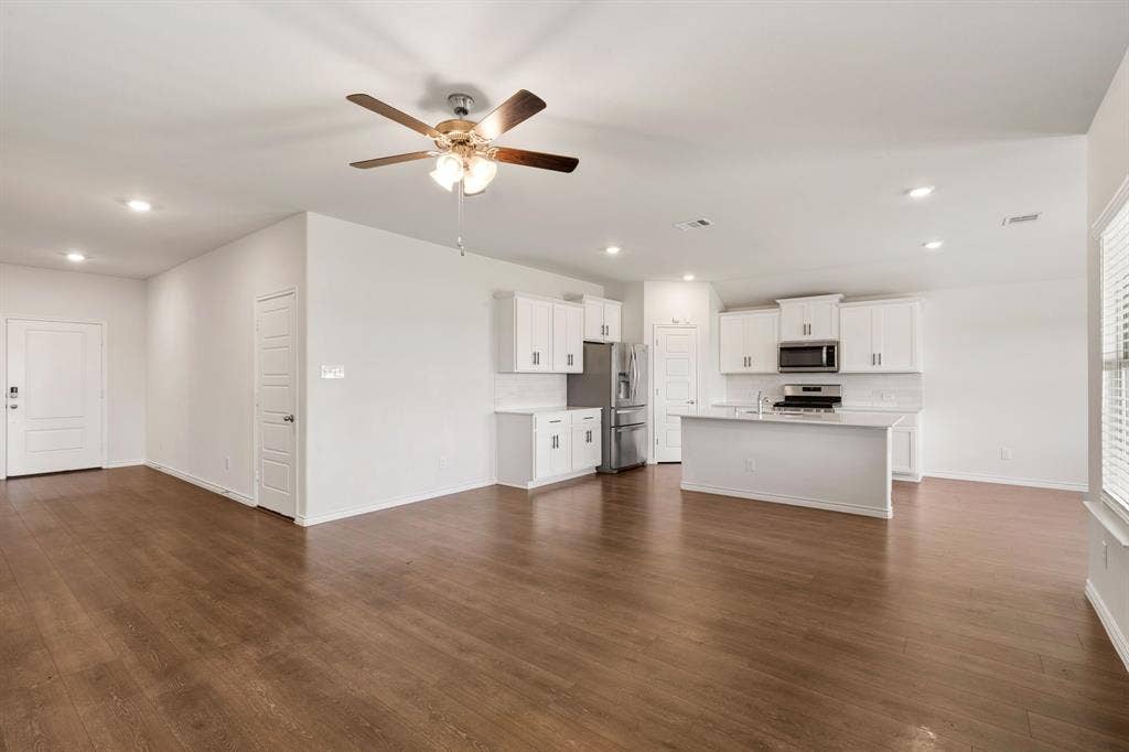653 Bunker Hill Road, Fate, TX 75189 Open-concept living area with wood-finish flooring, recessed lighting, and a ceiling fan