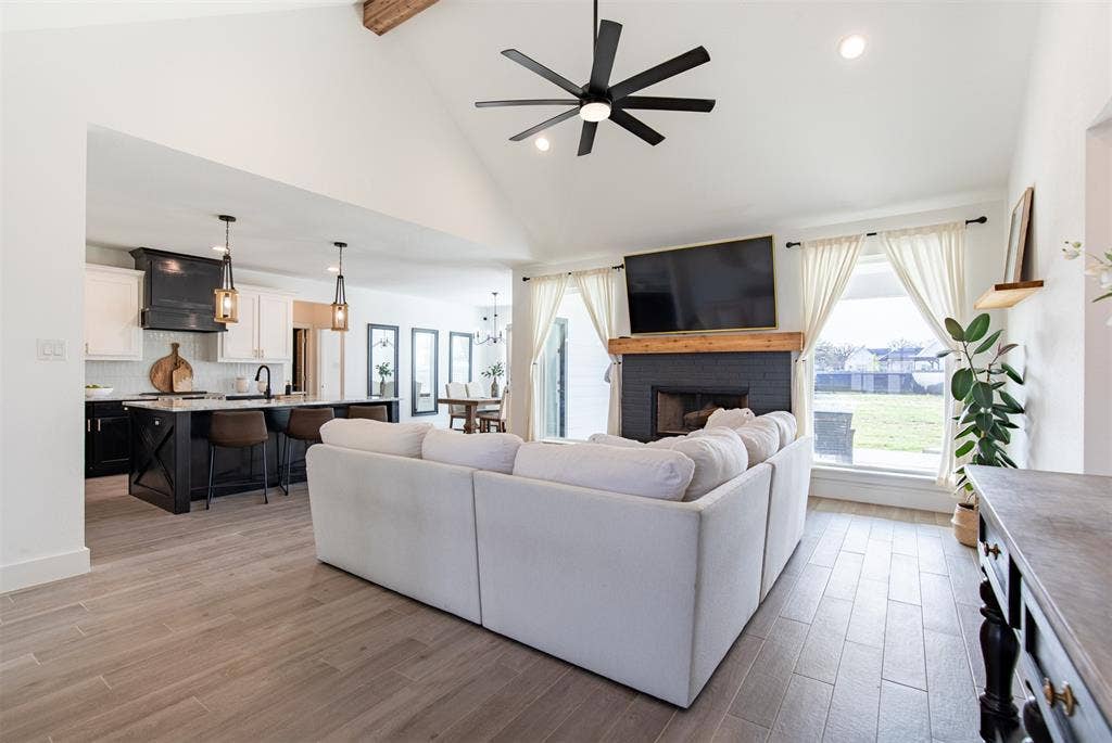 111 Bluegrass Trail, Springtown, TX 76082 Open-concept living room with vaulted ceiling with beam.