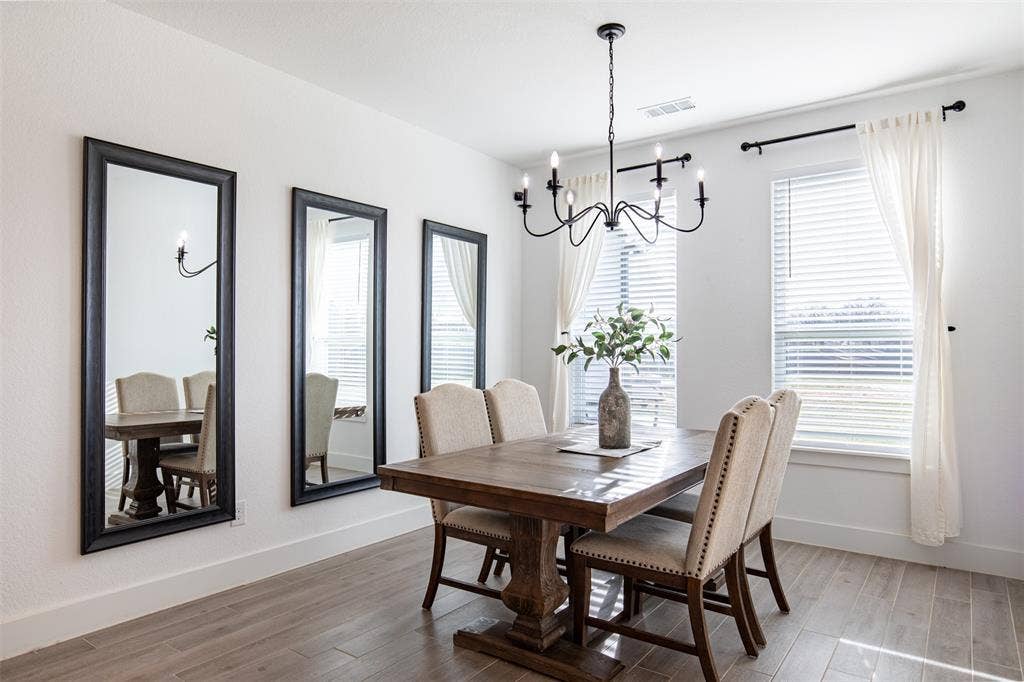 111 Bluegrass Trail, Springtown, TX 76082 Dining room with designer chandelier and wall of windows overlooking the scenic backyard.