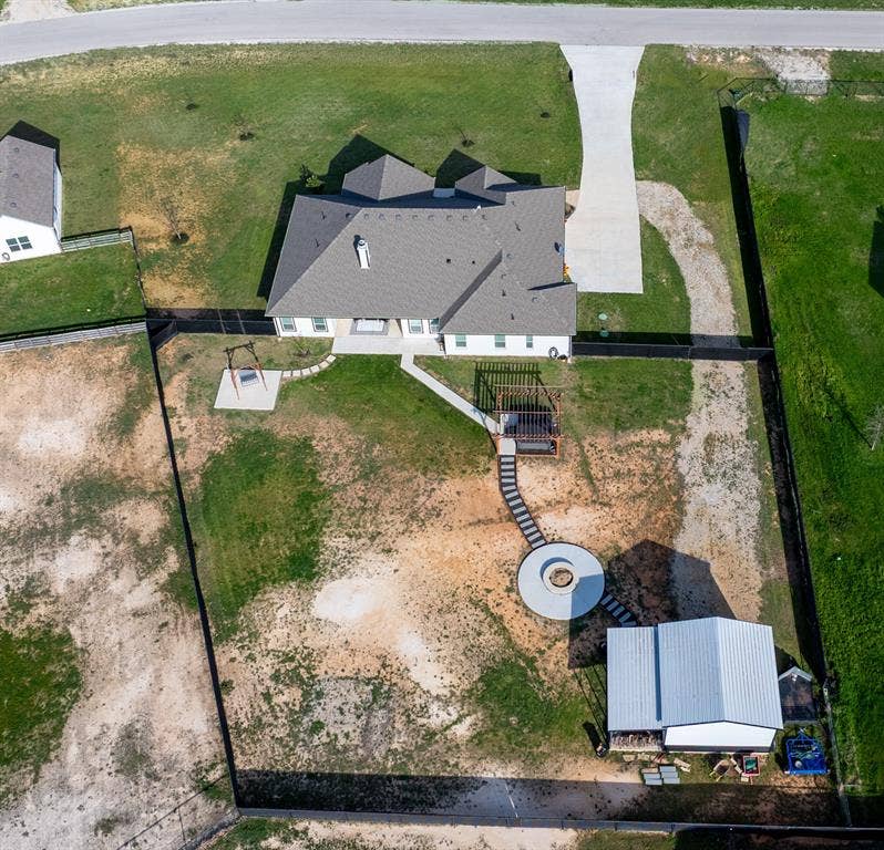 111 Bluegrass Trail, Springtown, TX 76082 Aerial view of back of home showcasing backyard.