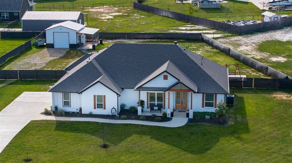 111 Bluegrass Trail, Springtown, TX 76082 Aerial view of front of home showcasing lot.