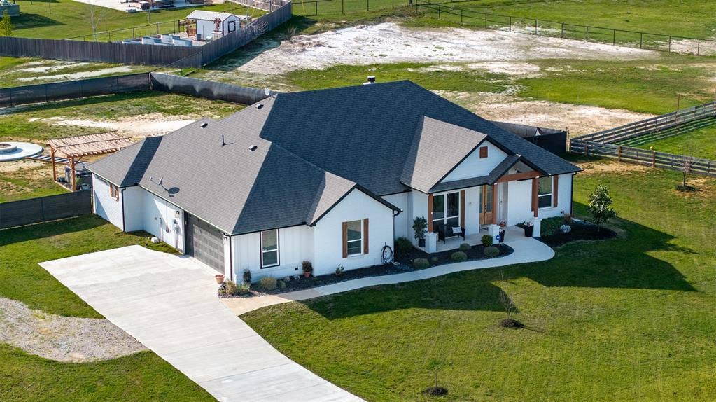 111 Bluegrass Trail, Springtown, TX 76082 Side entry garage enhances the beauty of the home.