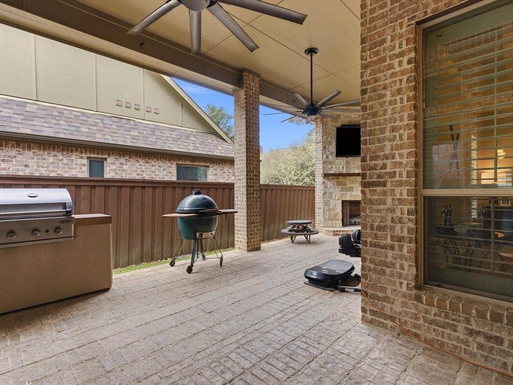 2115 N Hill Drive, Irving, TX 75038 Oversized ceiling fans, turbo gas grill, gas fireplace making it the perfect outdoor space.