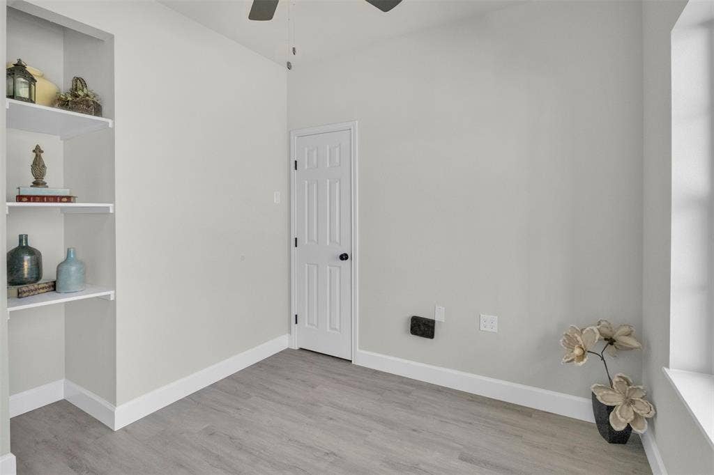 3415 Fm 3211, Caddo Mills, TX 75135 Empty room with ceiling fan, light wood finished floors, and built in features