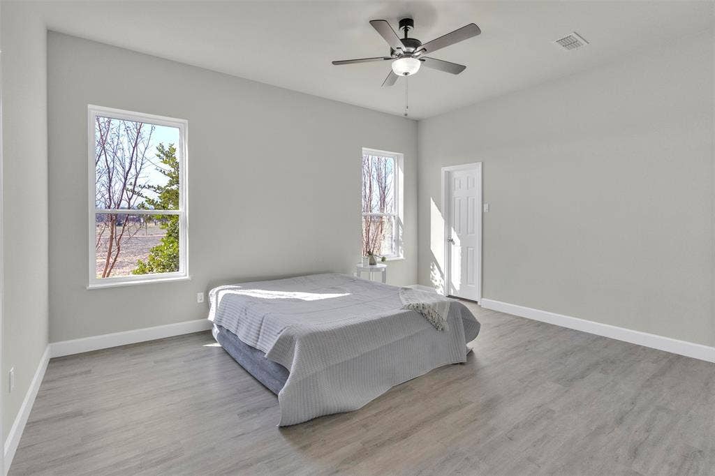 3415 Fm 3211, Caddo Mills, TX 75135 Bedroom featuring ceiling fan and light wood-style floors