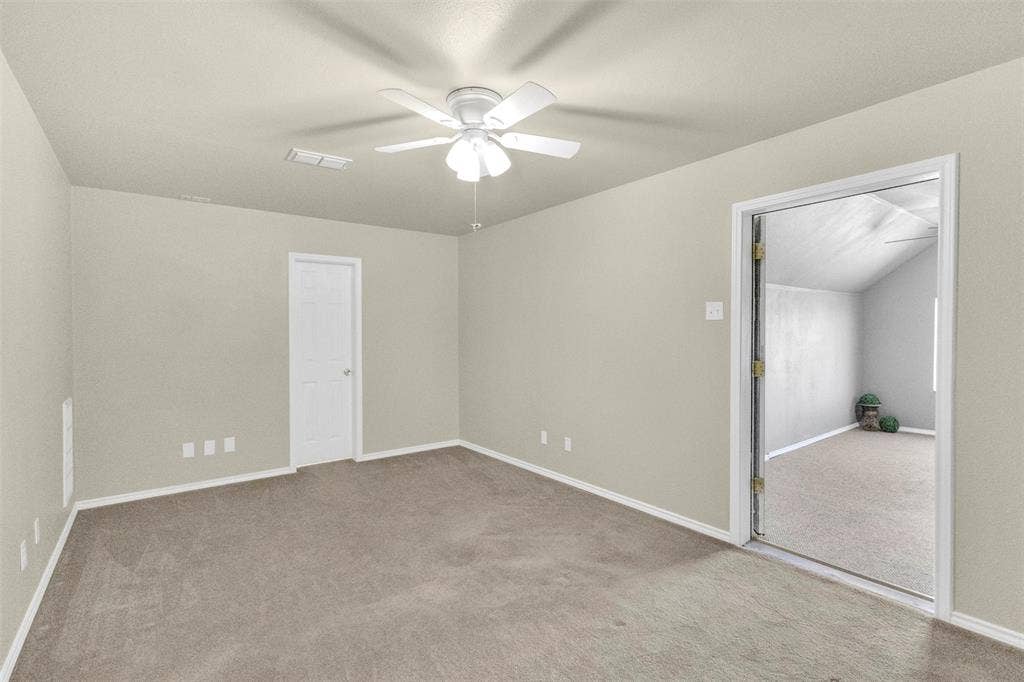 3415 Fm 3211, Caddo Mills, TX 75135 Unfurnished bedroom featuring light colored carpet and ceiling fan