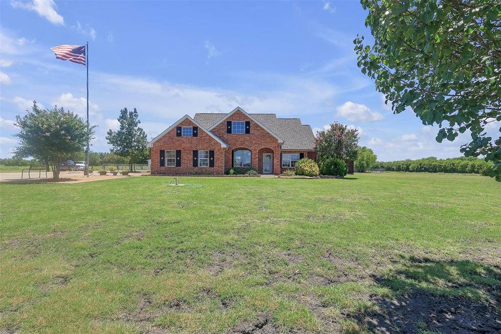 3415 Fm 3211, Caddo Mills, TX 75135 View of front facade with brick siding and a front yard