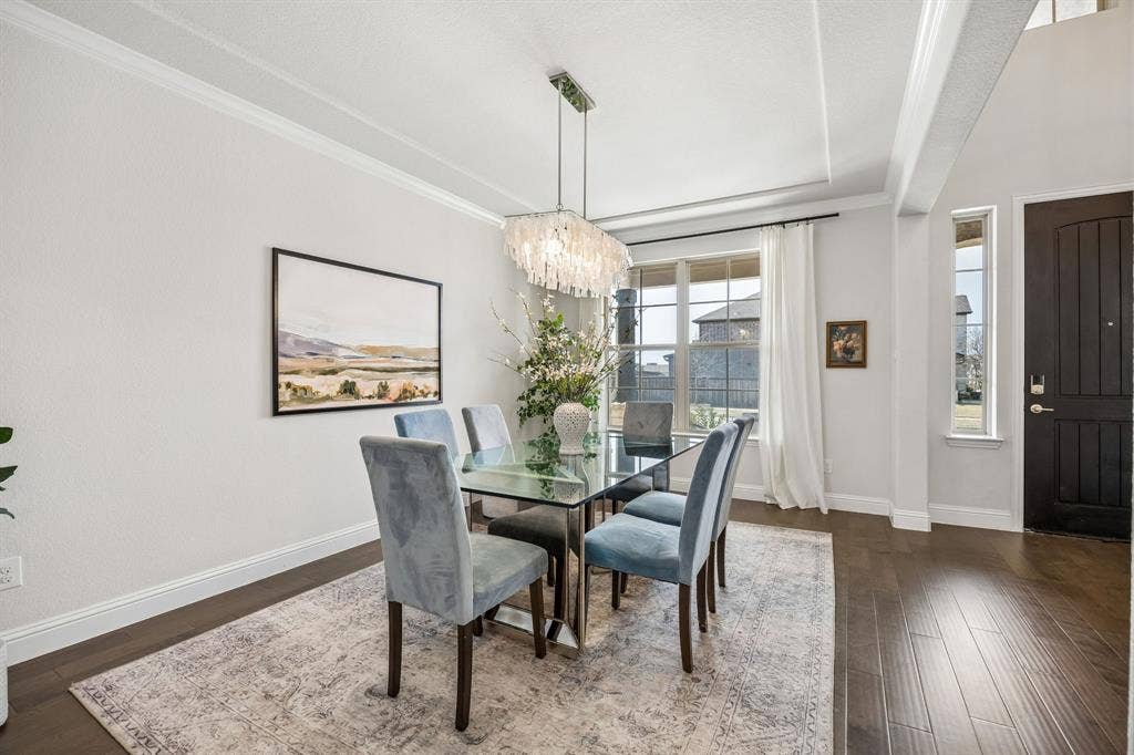 13674 Carmenita Drive, Frisco, TX 75035 Dining space with suspended lighting, ornamental molding, and dark wood-style floors