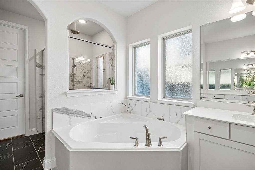 13674 Carmenita Drive, Frisco, TX 75035 Full bath featuring a marble finish shower, a garden tub, and vanity