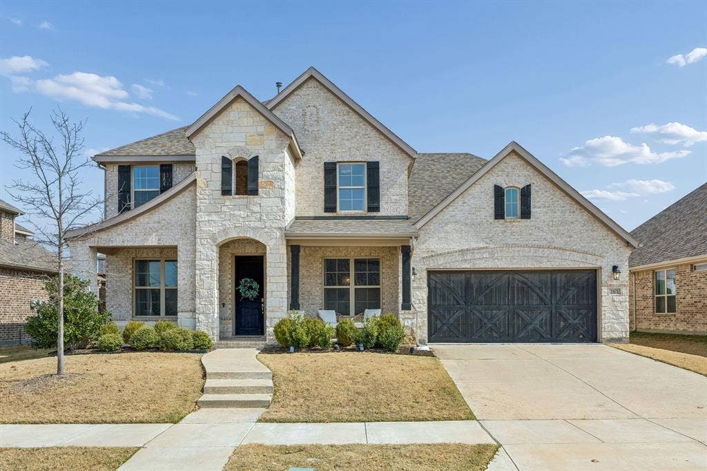 13674 Carmenita Drive, Frisco, TX 75035 French country home featuring a porch, stone siding, driveway, and brick siding