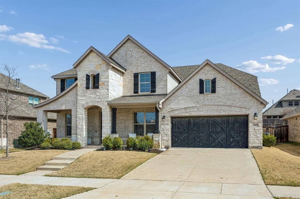 13674 Carmenita Drive, Frisco, TX 75035 French provincial home with covered porch, concrete driveway, brick siding, stone siding, and roof with shingles