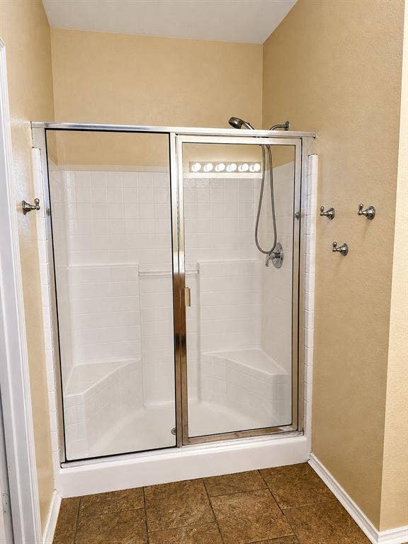103 Denali Court, Terrell, TX 75160 Enclosed shower featuring a handheld showerhead, built-in seating, and a glass sliding door