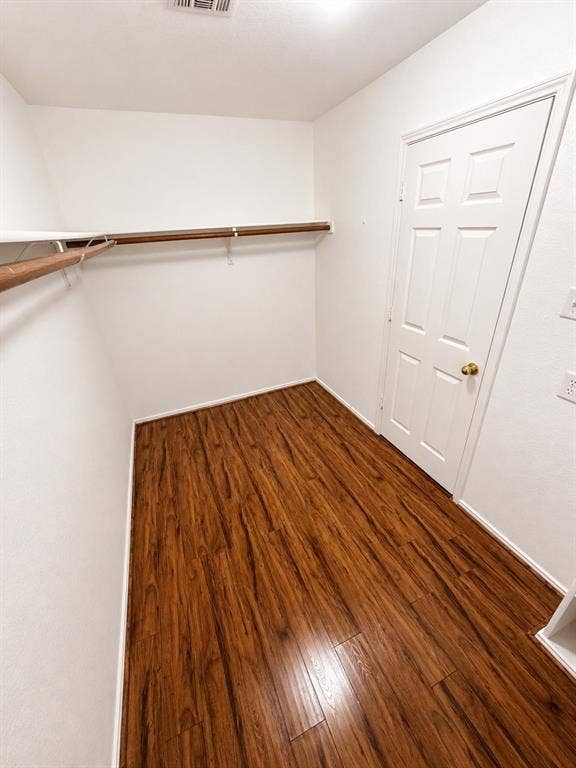 103 Denali Court, Terrell, TX 75160 Walk-in closet featuring wood-finish flooring, white walls, and a built-in hanging rod