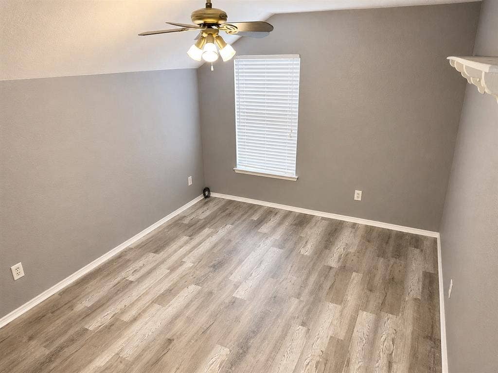 103 Denali Court, Terrell, TX 75160 Room with wood-finish flooring, neutral gray walls, and white baseboards