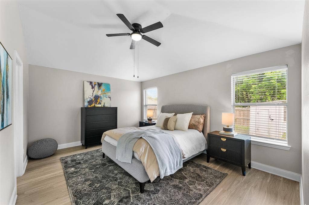 2408 Castle Ridge Drive, McKinney, TX 75071 Bedroom featuring light wood-style floors, ceiling fan, and lofted ceiling