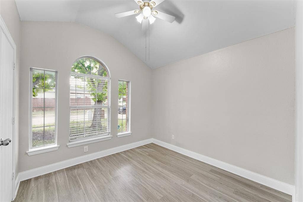 2408 Castle Ridge Drive, McKinney, TX 75071 Unfurnished room with ceiling fan, light wood-style flooring, and vaulted ceiling