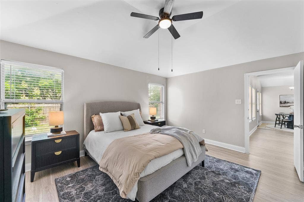 2408 Castle Ridge Drive, McKinney, TX 75071 Bedroom with vaulted ceiling, ceiling fan, and light wood finished floors