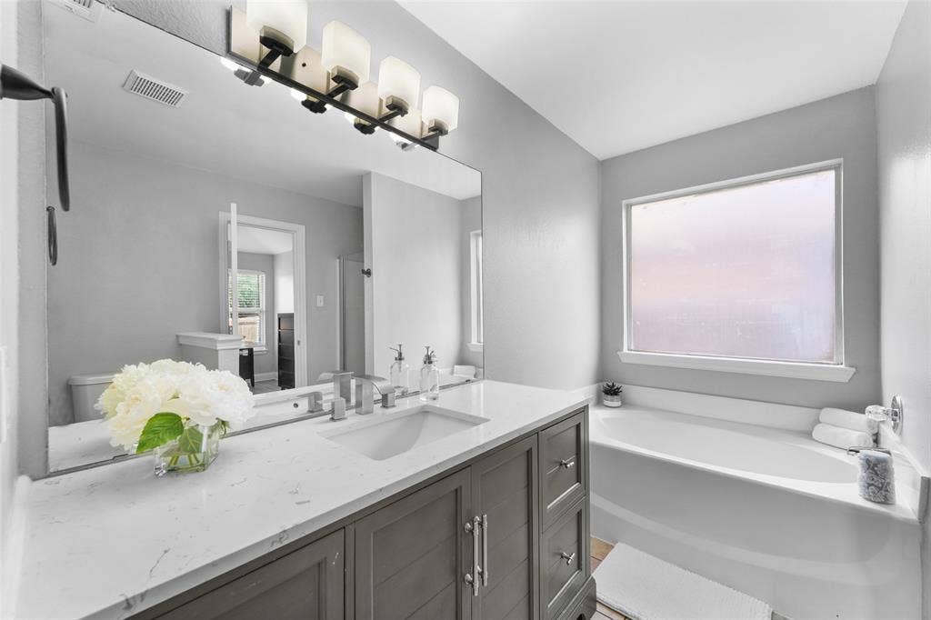 2408 Castle Ridge Drive, McKinney, TX 75071 Bathroom featuring vanity and a bath