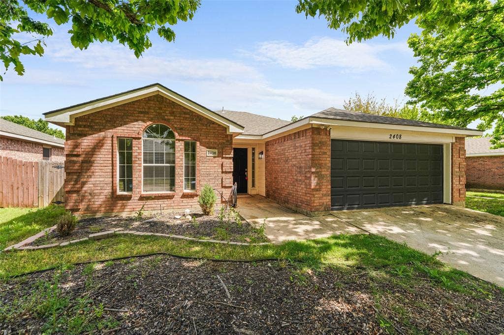 2408 Castle Ridge Drive, McKinney, TX 75071 Ranch-style home with a garage, driveway, and brick siding